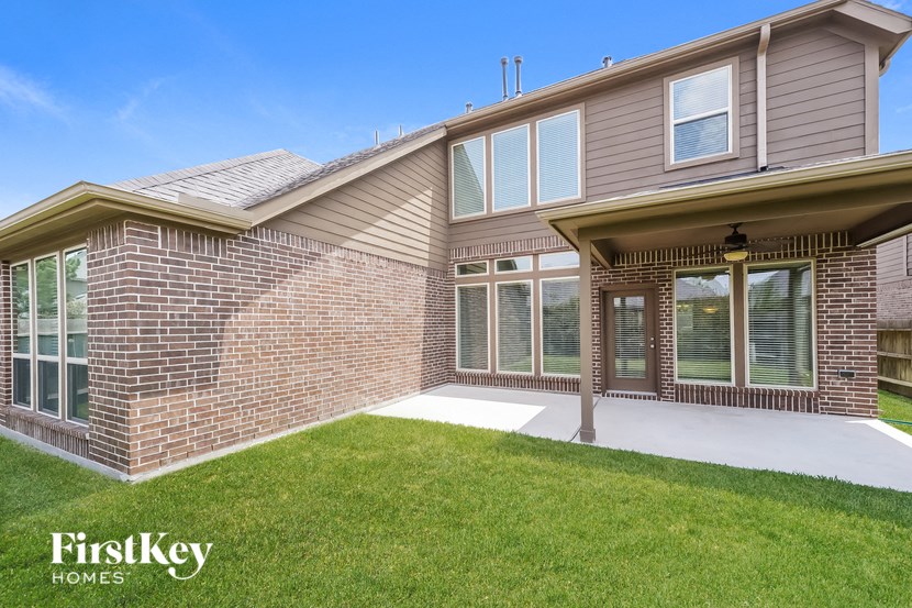 a home with a patio and a lawn