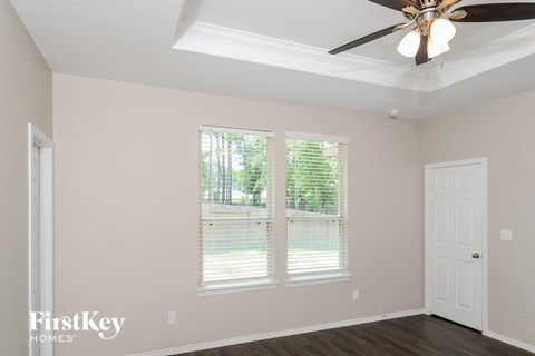 a living room with a ceiling fan and a window