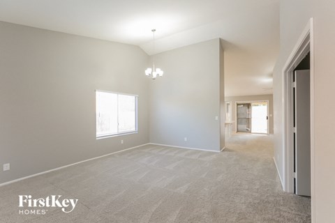 the living room and dining room with the hallway to the bedrooms