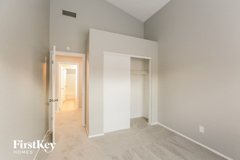 a bedroom with a closet and a hallway with an open door