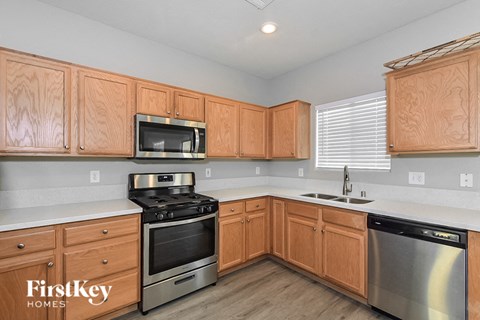 A kitchen with wooden cabinets and stainless steel appliances.