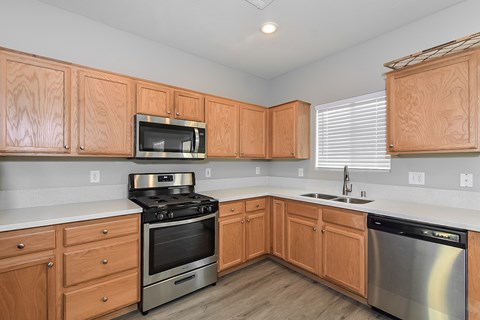 A kitchen with wooden cabinets and stainless steel appliances.