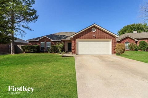 a clean driveway in front of a house with a garage door
