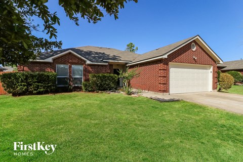 a home with a lawn and a garage