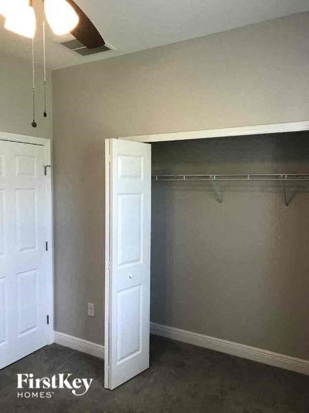 an empty room with a closet and two white doors