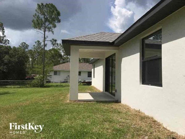 a white house with a lawn in front of it