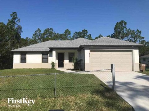 a house with a chain link fence in front of it
