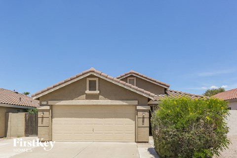 a garage in front of a house with a clear blue sky