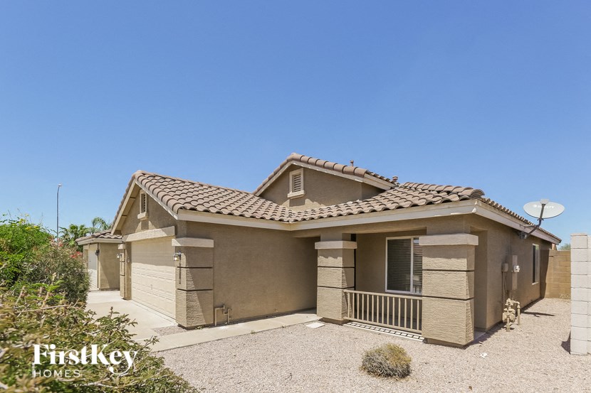a house with a driveway and a satellite dish on the side of it