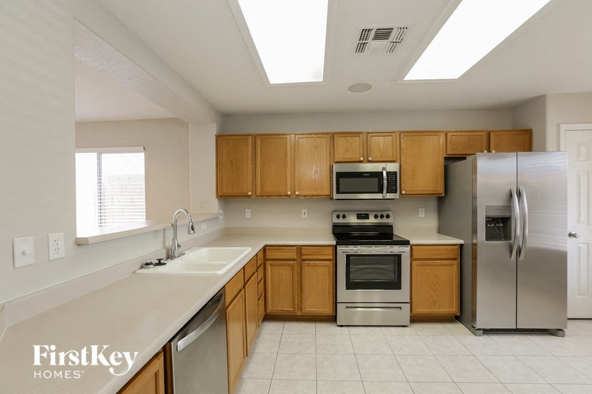 a kitchen with wooden cabinets and stainless steel appliances