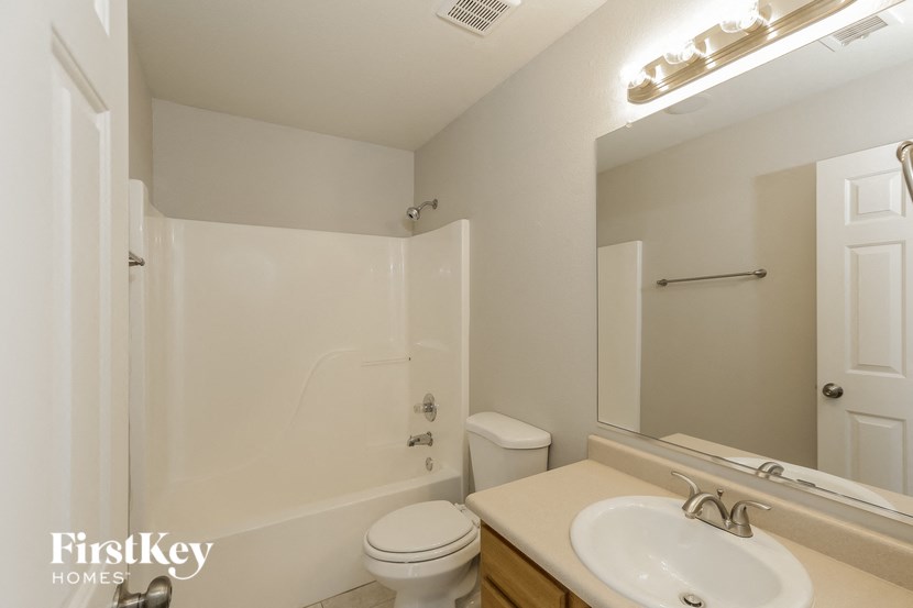 a bathroom with a sink and a shower and a toilet