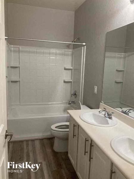 a bathroom with a toilet sink and a shower