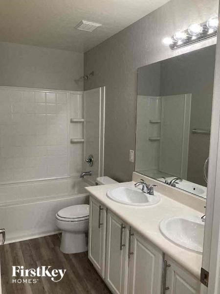 a bathroom with a toilet and a sink and a mirror