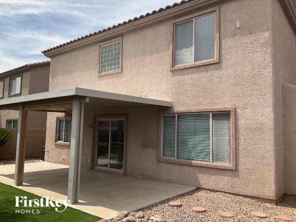 a brick house with a porch and a driveway