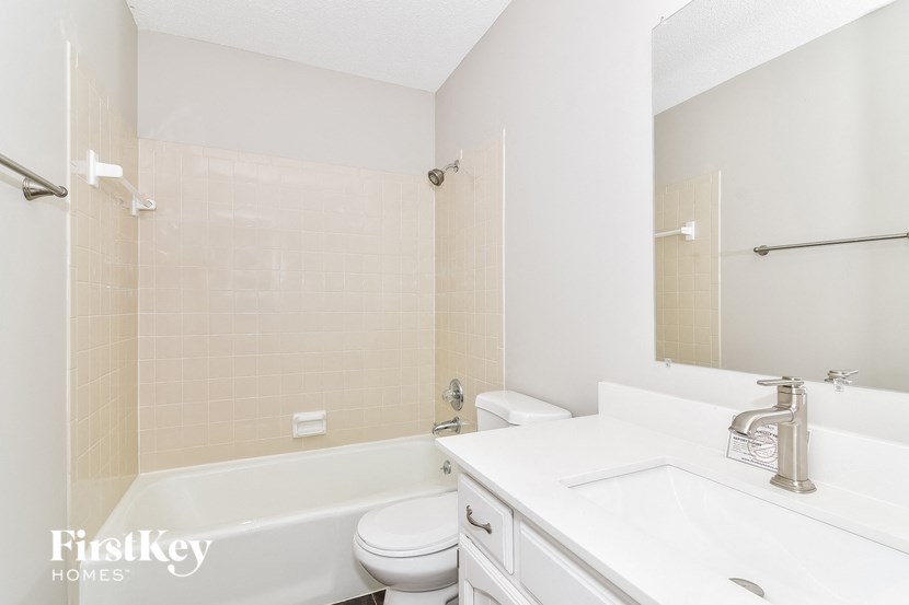 a white bathroom with a sink toilet and tub