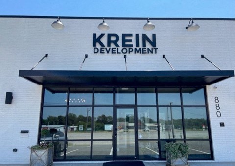 The front of a building with the name "KREIN DEVELOPMENT" on it.