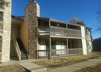 an apartment building with a balcony and stairs