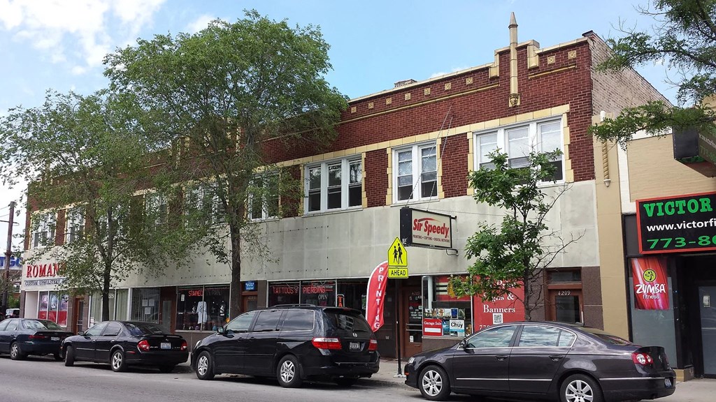 a city street with cars parked in front of a building