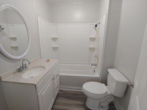 a small bathroom with a sink toilet and shower