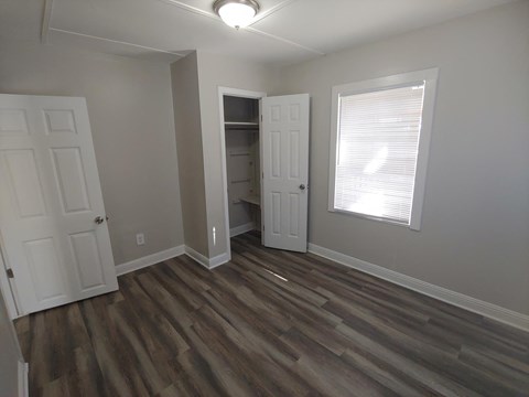 a living room with wooden floors and a closet