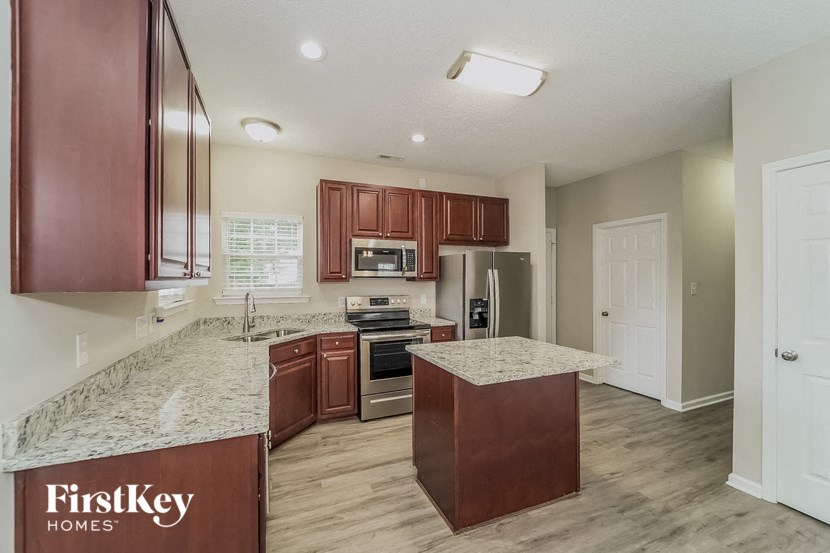 a kitchen with wooden cabinets and granite counter tops