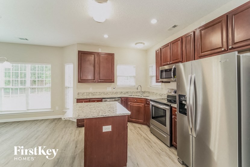 a kitchen with stainless steel appliances and wooden cabinets