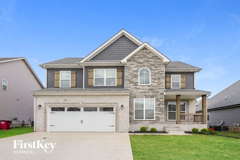 A two-story house with a garage is for sale.