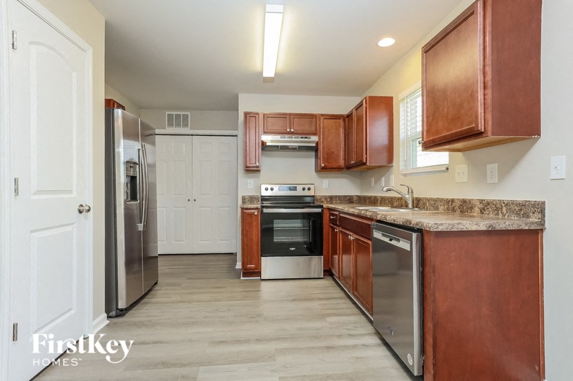 a kitchen with wooden cabinets and stainless steel appliances