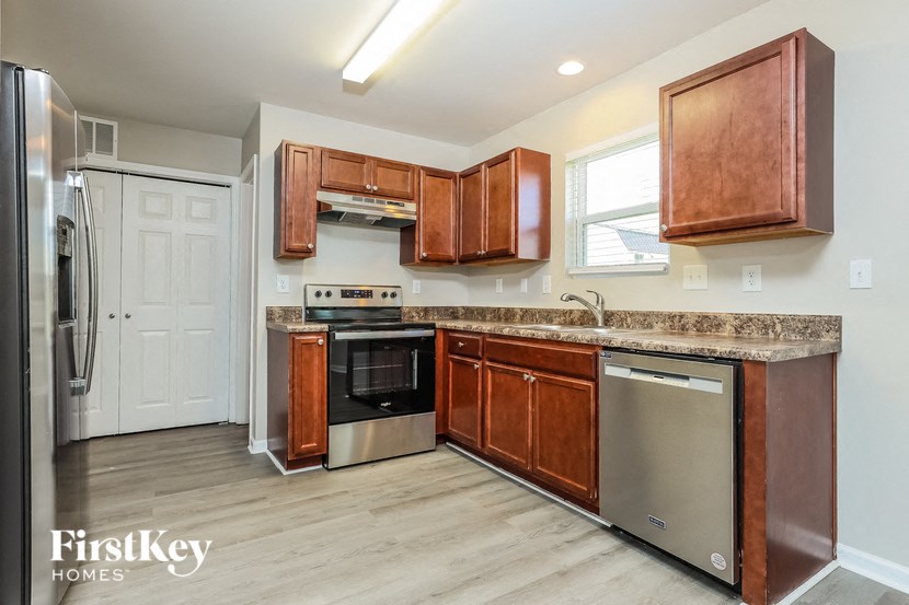 a kitchen with wooden cabinets and stainless steel appliances