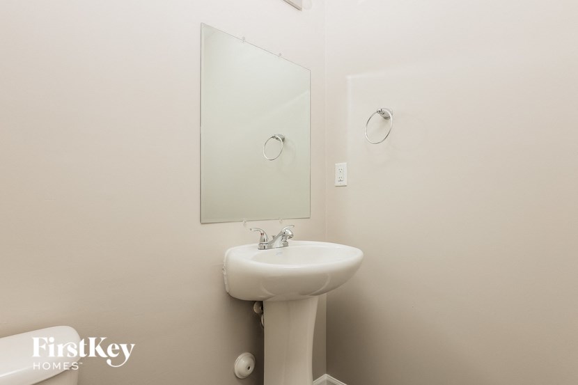 a small bathroom with a sink and a mirror
