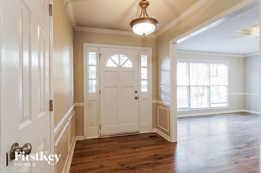 A room with a wooden floor and a white door.