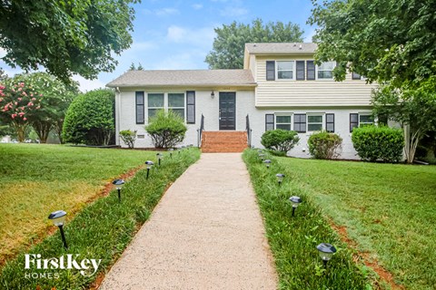 a white house with a walkway leading up to it