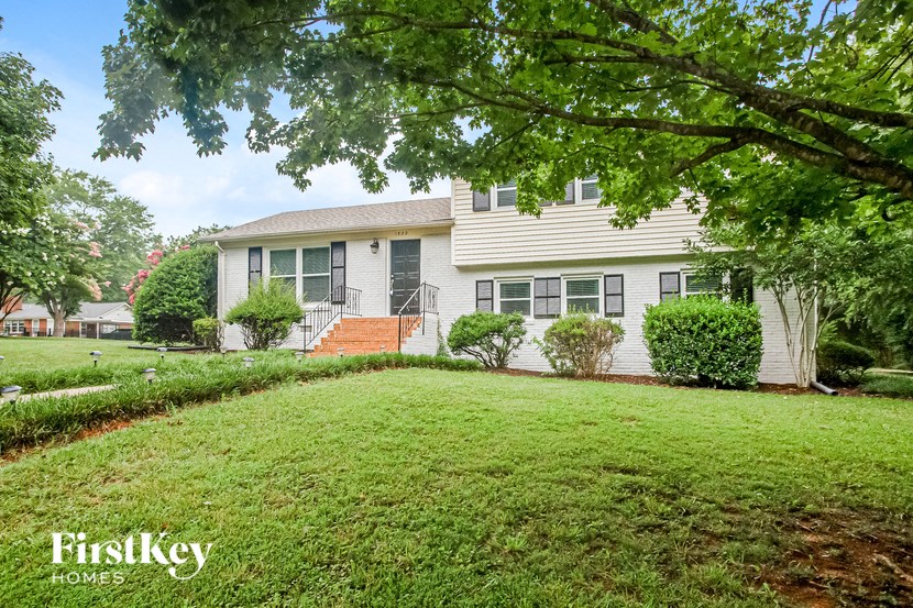 a white house with a yard in front of it