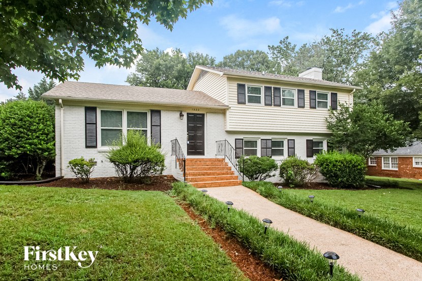 a white house with a lawn and a sidewalk