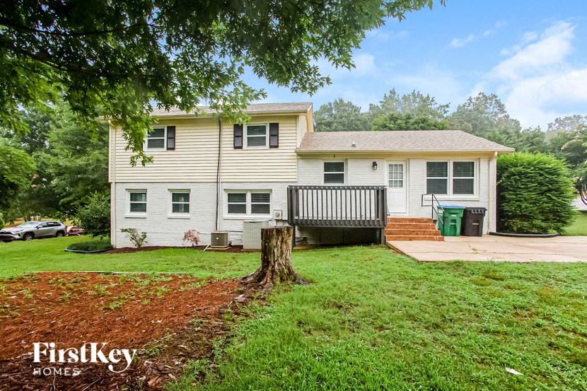 a white house with a yard and a deck