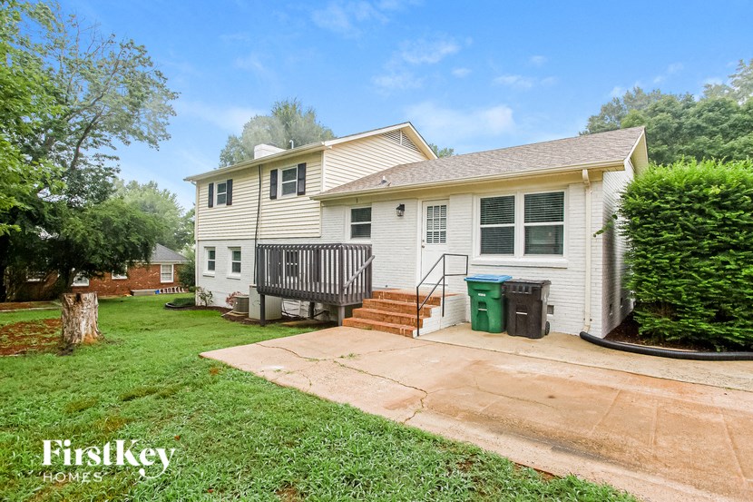 a white house with a yard and a driveway