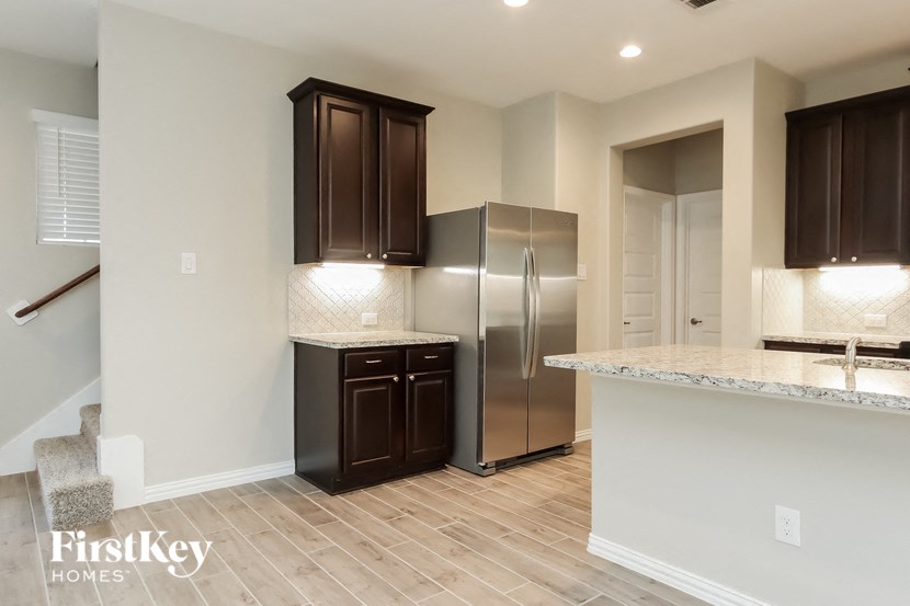 a kitchen with a stainless steel refrigerator and a counter top