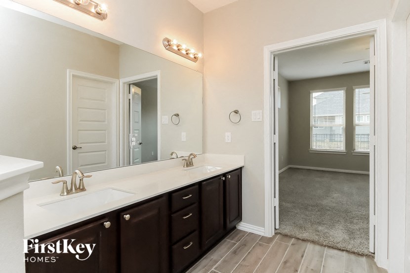 a bathroom with two sinks and a large mirror