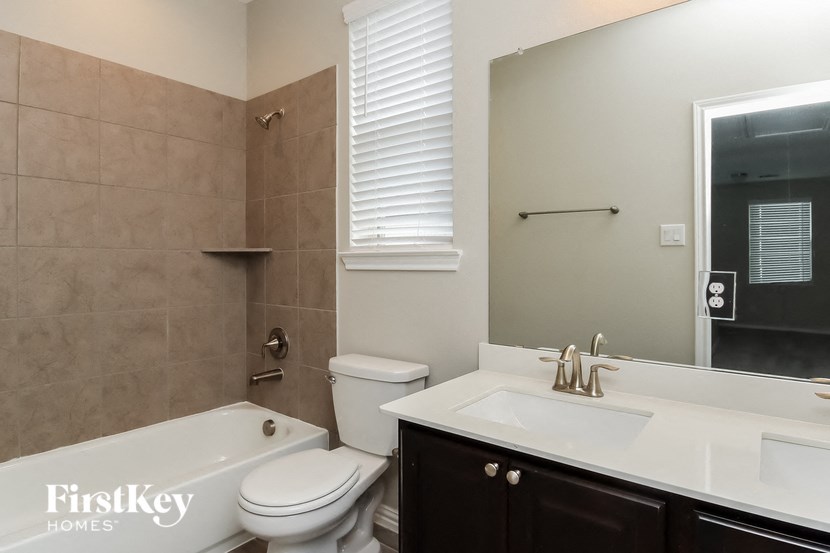 a bathroom with a sink toilet and a tub