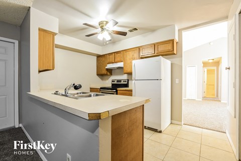 a kitchen with a sink and a refrigerator
