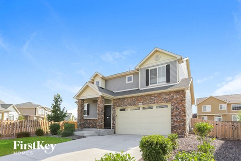 a brick house with a white garage door