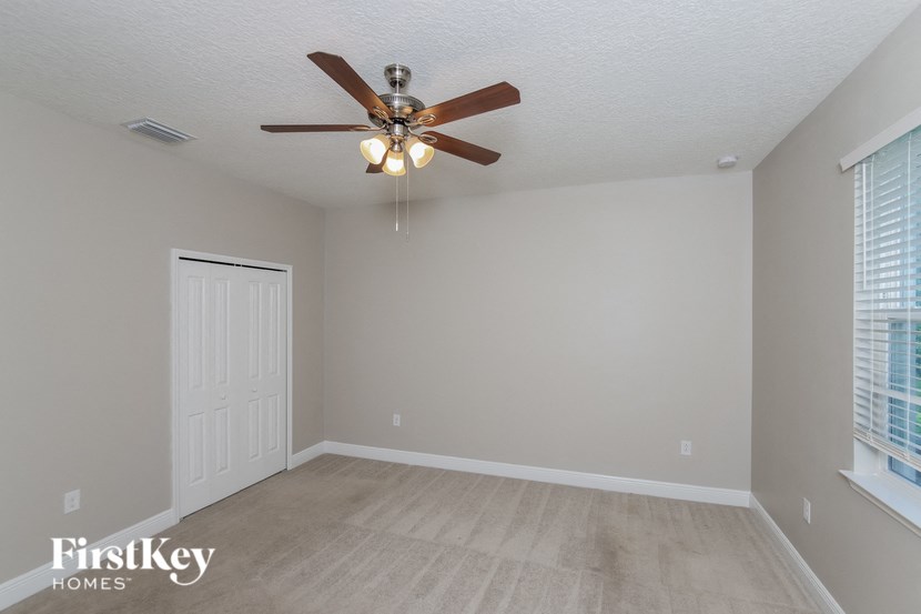 the living room of a home with a ceiling fan