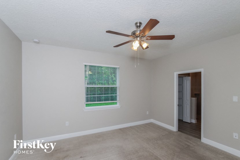 a living room with a ceiling fan and a window
