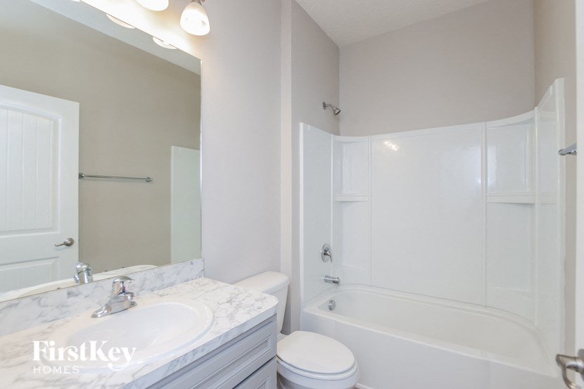 a bathroom with a sink toilet and a bath tub