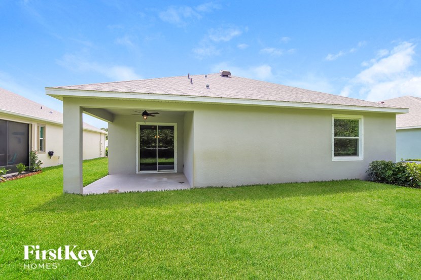 a white house with a lawn and a door
