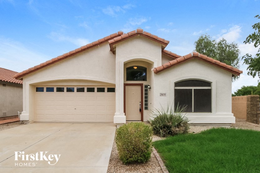 A house with a brown roof and a garage door.