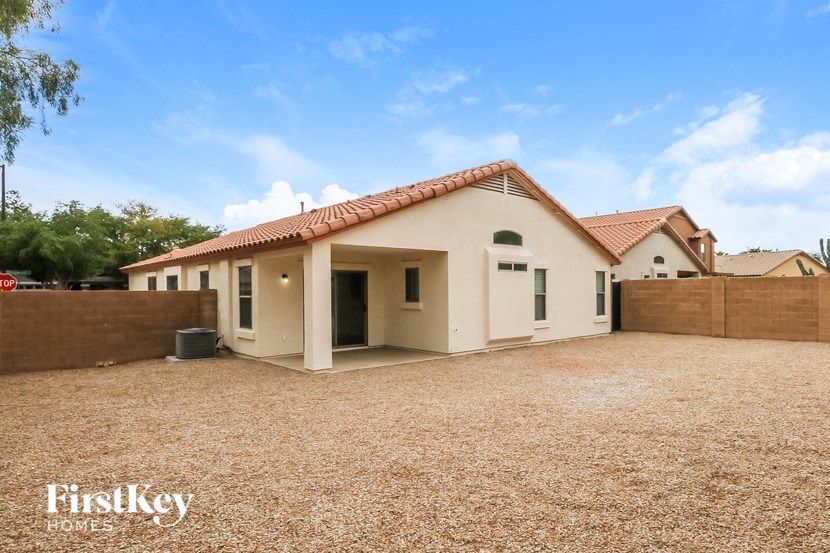 A house with a brown roof and a brown fence is for sale.