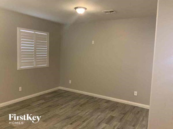 a empty room with wood floors and a window