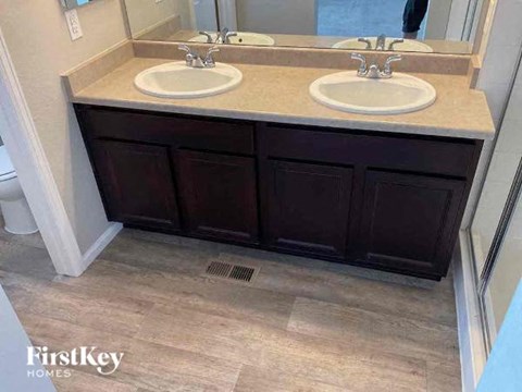 a bathroom with two sinks and a mirror