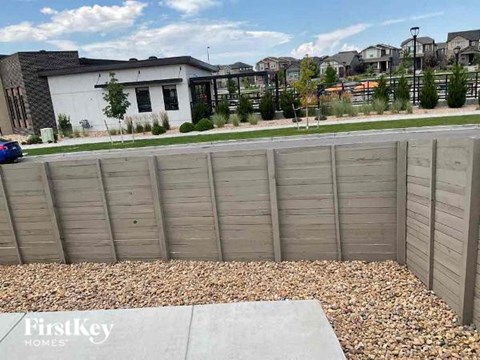 a wooden fence on the side of a street